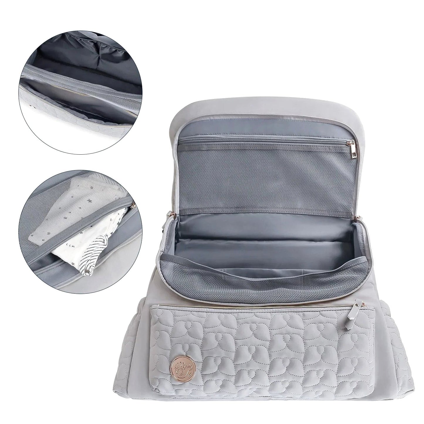The gray Cloudscape Diaper Backpack open, showcasing its organized interior with mesh pockets. Inset images provide a closer look at a zippered pocket and a mesh pocket containing a baby outfit.