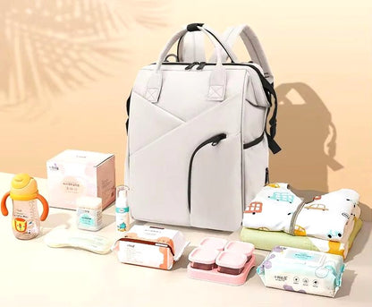 Cloudscape Modern Diaper Backpack in light grey, displayed with various baby essentials like wipes, baby food containers, baby clothes, and a bottle, showcasing its large capacity and organization.