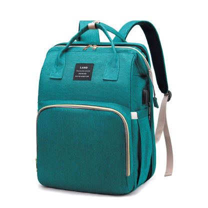 Nimbus Tote Diaper Backpack in teal green, shown from the front view. This multi-functional bag offers organized storage and durable fabric for baby essentials.