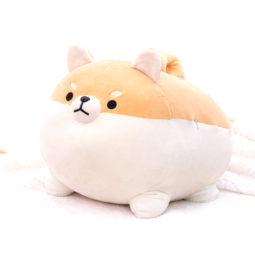 Close-up of a single brown and white Shiba Inu plush toy on a soft white fluffy blanket. Adorable kawaii dog plushie.